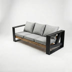 Modern outdoor sofa with black frame and gray cushions on a white background