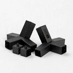 Black metal 3D-printed 3D-printing accessories, including three T-brackets and three small cube blocks with mounting holes, arranged on a light gray background. One of the T-brackets features the brand name 'KUKU' printed on its side.
