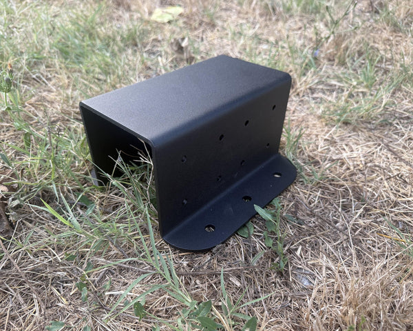 Black metal bracket on a grassy ground