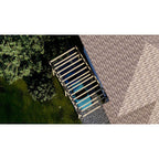 Aerial view of a wooden staircase leading to a roof with a blue pool below.